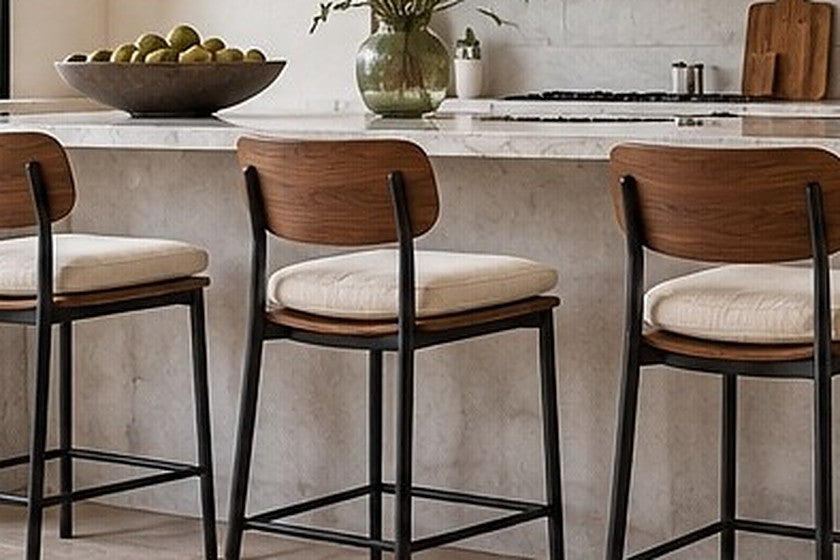 Bar stools with removable ivory seat cushions at a kitchen island